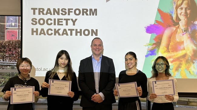 Student winners of the Transform Society hackathon collect their certificates with James Darley, CEO of Transform Society.